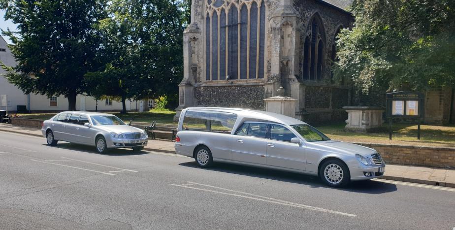 Silver hearse and limousine at Mildenhall